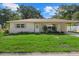 Newly remodeled tan single-story house with a carport and grassy lawn at 5315 24Th St W, Bradenton, FL 34207