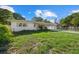 Tan single story house with carport, landscaped lawn, and fenced backyard at 5315 24Th St W, Bradenton, FL 34207