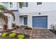 Townhouse exterior with blue garage door and brick walkway at 5413 Tripoli Dr, Palmetto, FL 34221