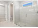 Large walk-in shower with glass enclosure and neutral tile at 5628 Long Shore Loop, Sarasota, FL 34238