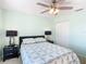 Bright bedroom with ceiling fan, double closets, and patterned bedding at 5725 Greenwood Ave # 6203, North Port, FL 34287