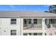 Exterior view of building with balcony, showing light-colored building and landscaping at 5725 Greenwood Ave # 6203, North Port, FL 34287