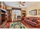 Relaxing living room featuring a leather sofa and built-in shelving at 6340 Watercrest Way # 202, Lakewood Ranch, FL 34202