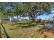 Spacious backyard with large shade tree, wood fence, and grassy area at 6415 Coliseum Blvd, Port Charlotte, FL 33981