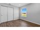 Cheerful bedroom with wood-look floors and window with natural light at 6415 Coliseum Blvd, Port Charlotte, FL 33981