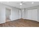 Bright bedroom with wood-look floors, ceiling fan, and access to bathroom at 6415 Coliseum Blvd, Port Charlotte, FL 33981