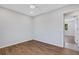 Spacious bedroom with wood-look floors and access to the bathroom at 6415 Coliseum Blvd, Port Charlotte, FL 33981