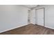 Bright bedroom with wood-look floors and double doors to closet at 6415 Coliseum Blvd, Port Charlotte, FL 33981