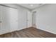 Bedroom with wood-look floors, double doors and access to bath at 6415 Coliseum Blvd, Port Charlotte, FL 33981
