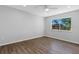 Bright bedroom with wood-look floors and a window at 6415 Coliseum Blvd, Port Charlotte, FL 33981