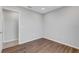 Simple bedroom with wood-look floors and access to bathroom at 6415 Coliseum Blvd, Port Charlotte, FL 33981
