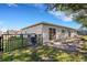 Rear view of the house, showcasing a patio area and access gate to the backyard at 6415 Coliseum Blvd, Port Charlotte, FL 33981