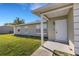 Tan house exterior with white door and small porch at 6415 Coliseum Blvd, Port Charlotte, FL 33981