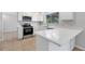 Modern kitchen with white cabinets and stainless steel appliances at 6415 Coliseum Blvd, Port Charlotte, FL 33981
