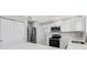 Modern kitchen with white cabinets and stainless steel appliances at 6415 Coliseum Blvd, Port Charlotte, FL 33981