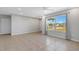 Living room with large window, tile floors, and access to other rooms at 6415 Coliseum Blvd, Port Charlotte, FL 33981