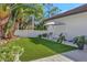 Artificial turf backyard with seating area and lush landscaping at 7003 River Club Blvd, Bradenton, FL 34202