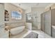 Spa-like bathroom with freestanding tub and walk-in shower at 7003 River Club Blvd, Bradenton, FL 34202