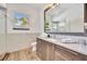 Modern bathroom with wood vanity, walk-in shower, and stylish fixtures at 7003 River Club Blvd, Bradenton, FL 34202
