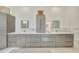 Elegant bathroom with gray cabinetry and white marble floors at 7003 River Club Blvd, Bradenton, FL 34202