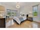Spacious bedroom with light wood floors, large windows, and stylish decor at 7003 River Club Blvd, Bradenton, FL 34202