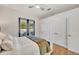 Bright bedroom with wood floors, white built-in closets, and access to the pool at 7003 River Club Blvd, Bradenton, FL 34202