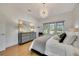 Bright bedroom with hardwood floors, large windows and modern dresser at 7003 River Club Blvd, Bradenton, FL 34202