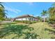 Side view of single-story house with manicured lawn at 7003 River Club Blvd, Bradenton, FL 34202