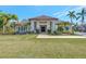Modern home with tile roof and walkway, surrounded by tropical landscaping at 7003 River Club Blvd, Bradenton, FL 34202