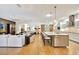 Open kitchen with island, stainless steel appliances, and hardwood floors at 7003 River Club Blvd, Bradenton, FL 34202