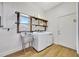 Laundry room with farmhouse sink and industrial shelving at 7003 River Club Blvd, Bradenton, FL 34202