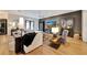 Living area with sectional sofa, hardwood floors, and a large TV at 7003 River Club Blvd, Bradenton, FL 34202