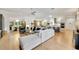 Spacious living room with hardwood floors, sectional sofa, and views into the kitchen and dining areas at 7003 River Club Blvd, Bradenton, FL 34202