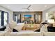 Living room with sectional sofa, hardwood floors, and a large TV at 7003 River Club Blvd, Bradenton, FL 34202