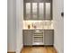 Built-in wet bar with wine cooler and glass-front cabinets at 7003 River Club Blvd, Bradenton, FL 34202