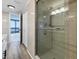 Bathroom with a walk-in shower and access to balcony with water view at 7100 Sunshine Skyway S Ln # 706, St Petersburg, FL 33711