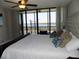 King-size bed in a bright bedroom with water views at 7100 Sunshine Skyway S Ln # 706, St Petersburg, FL 33711