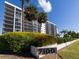 Condo building entrance with landscaping and address number at 7100 Sunshine Skyway S Ln # 706, St Petersburg, FL 33711