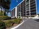 Condo building exterior showcasing landscaping and parking at 7100 Sunshine Skyway S Ln # 706, St Petersburg, FL 33711