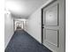 Clean condo hallway with carpeted floors at 7100 Sunshine Skyway S Ln # 706, St Petersburg, FL 33711