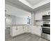 Modern white kitchen with granite countertops and stainless steel appliances at 7100 Sunshine Skyway S Ln # 706, St Petersburg, FL 33711