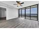 Living room with hardwood floors and access to a balcony with water views at 7100 Sunshine Skyway S Ln # 706, St Petersburg, FL 33711