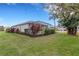 Landscaped backyard with spacious lawn and screened patio at 7153 Drewrys Blf, Bradenton, FL 34203