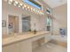 Spacious bathroom with double sinks, a large mirror, and a separate tub at 7153 Drewrys Blf, Bradenton, FL 34203