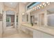 Bright bathroom with double sinks and a view of the bedroom at 7153 Drewrys Blf, Bradenton, FL 34203