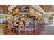 Clubhouse bar with numerous barstools and large TV at 7153 Drewrys Blf, Bradenton, FL 34203