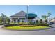 Elegant clubhouse exterior with circular driveway and landscaping at 7153 Drewrys Blf, Bradenton, FL 34203