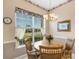 Bright dining area with wood table and four chairs, overlooking backyard at 7153 Drewrys Blf, Bradenton, FL 34203