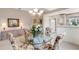Charming dining room featuring a glass-top table and floral patterned chairs at 7153 Drewrys Blf, Bradenton, FL 34203