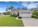 One-story house with a white garage door and manicured lawn at 7153 Drewrys Blf, Bradenton, FL 34203